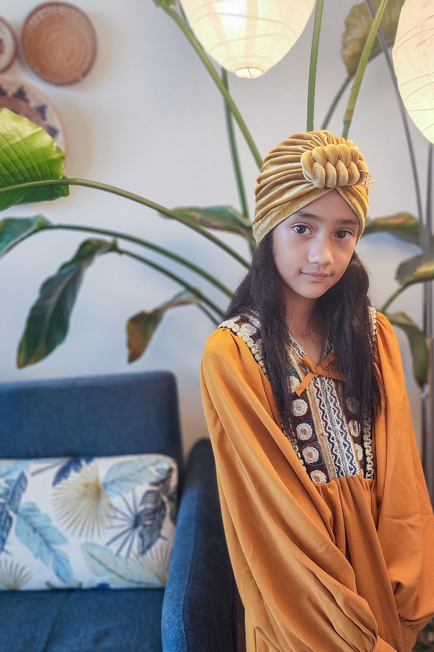 Velvet turban knot in gold color close-up view