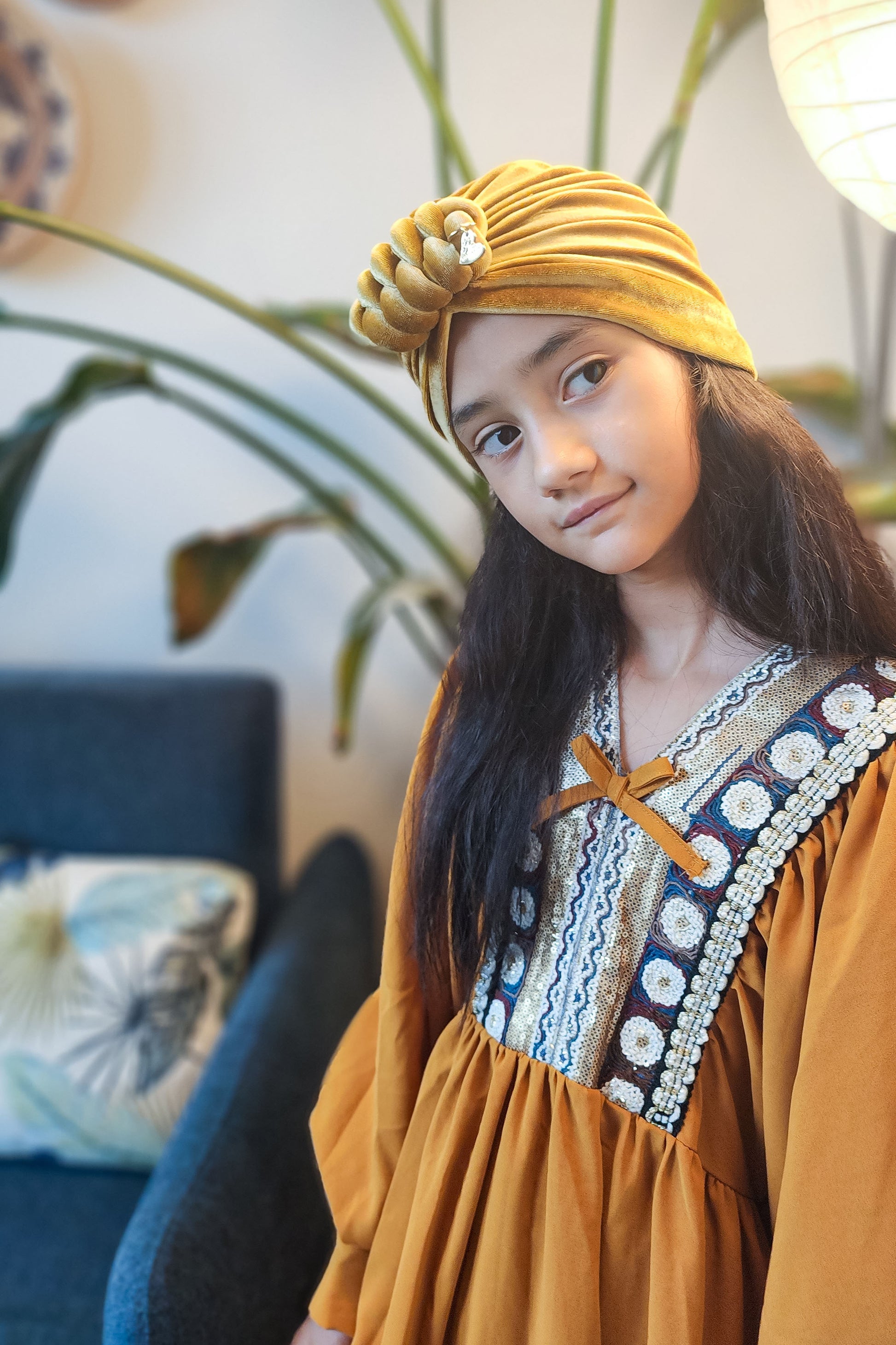 Velvet turban knot in gold color close-up view