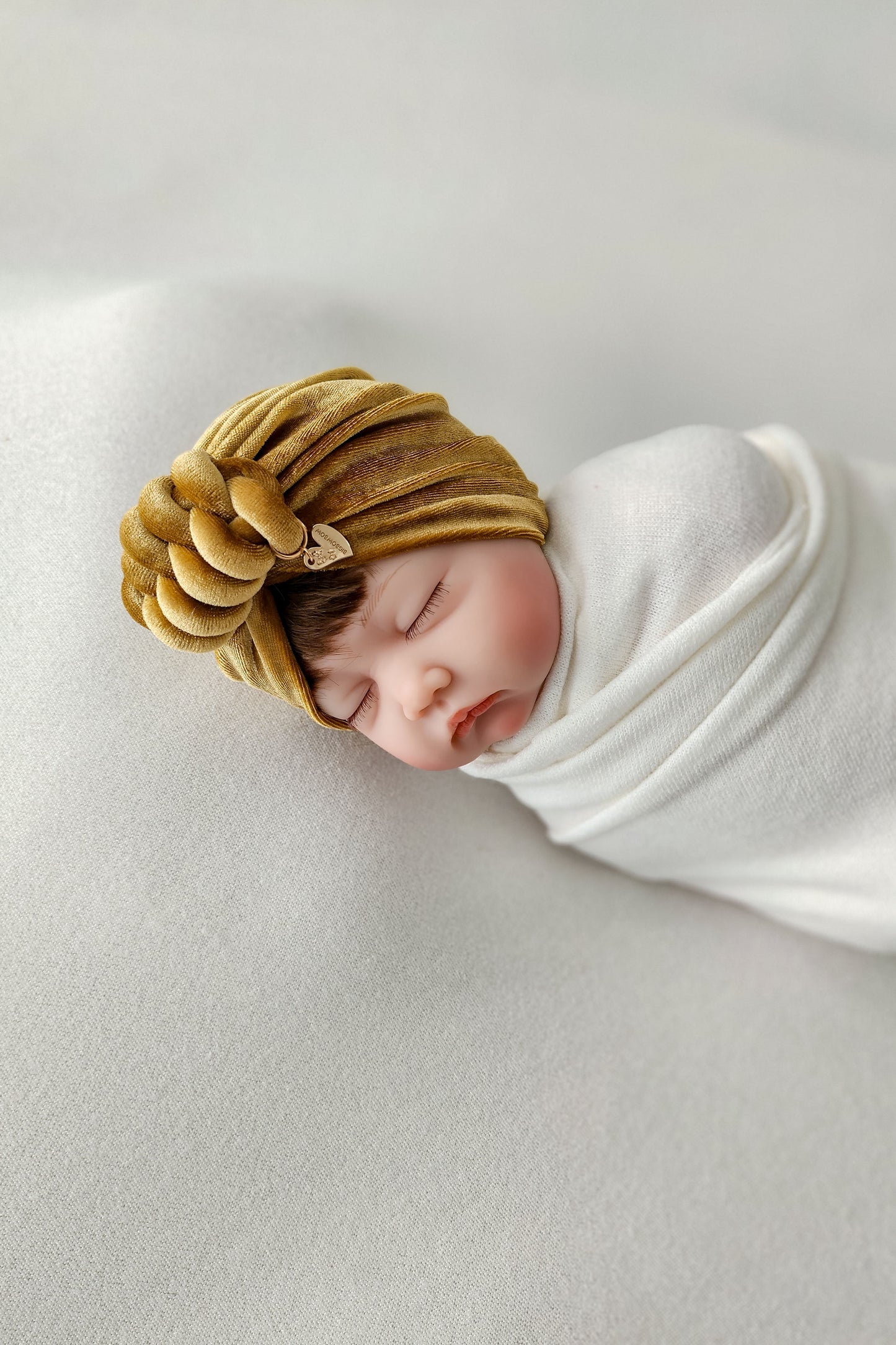 Baby girl velvet turban knot in gold color side view