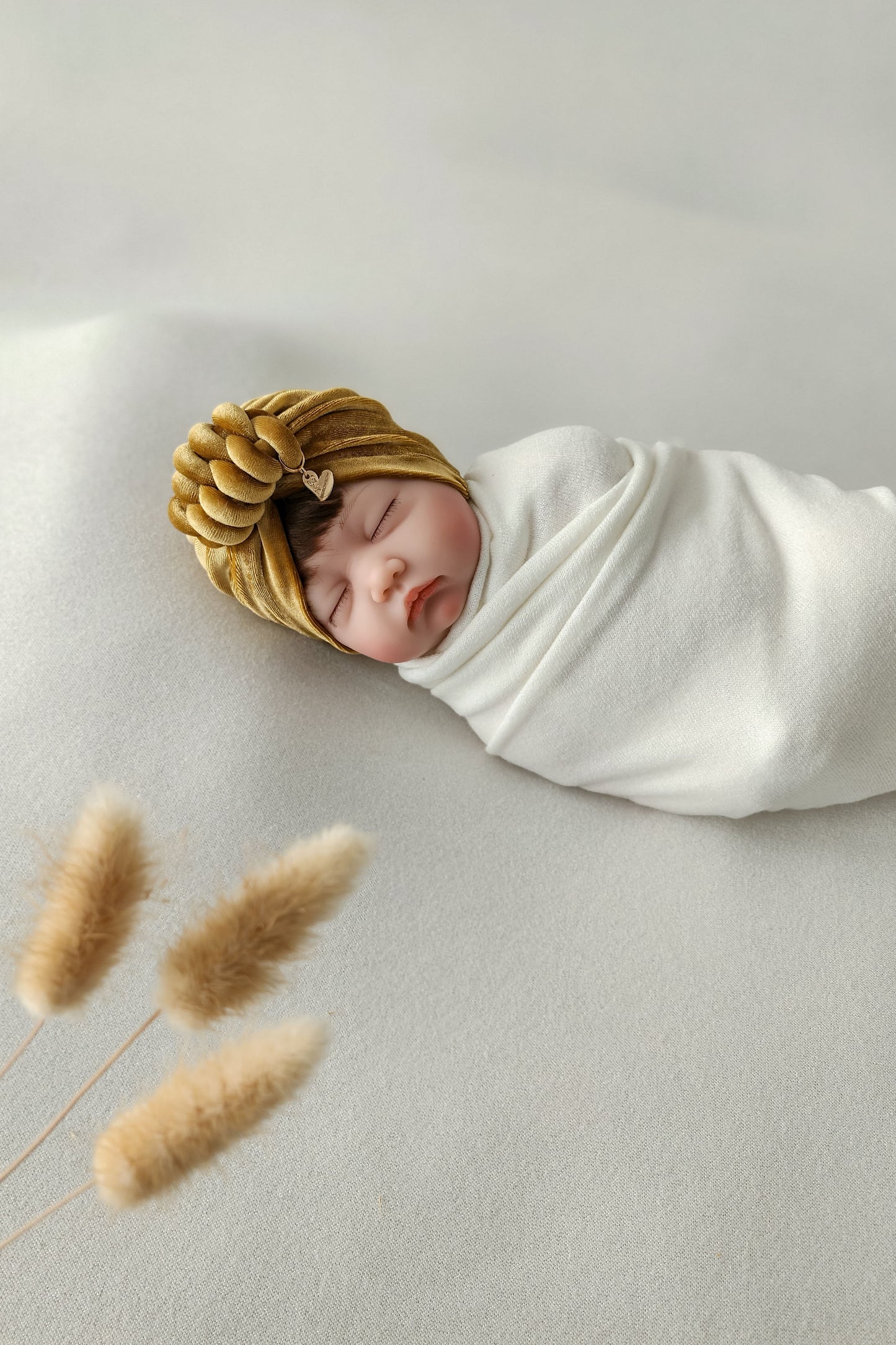 Baby girl velvet turban knot in gold color close-up view