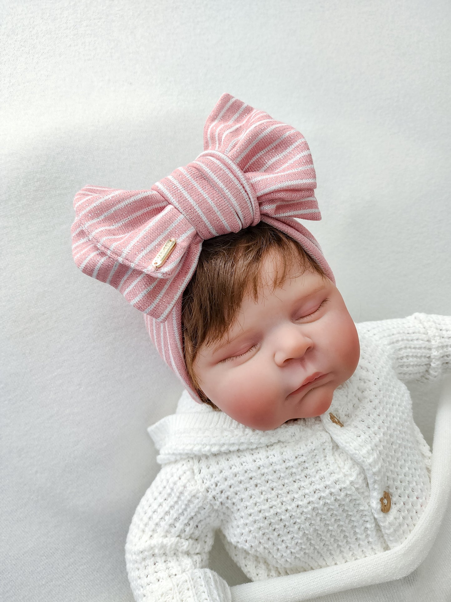 Oversized head wrap bow for baby and adults, glitter pink stripe. front view