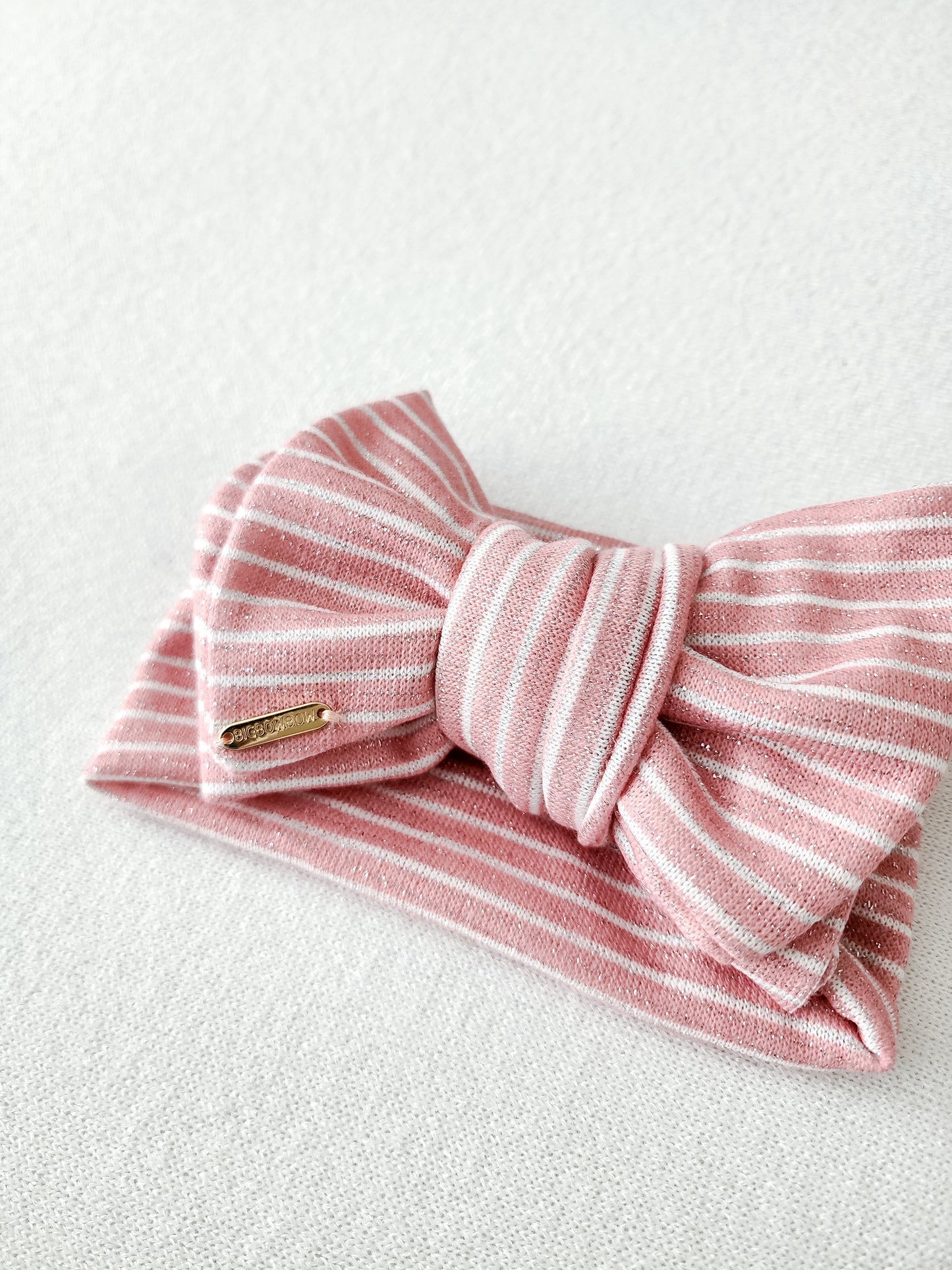 Oversized head wrap bow for baby and adults, glitter pink stripe. side view