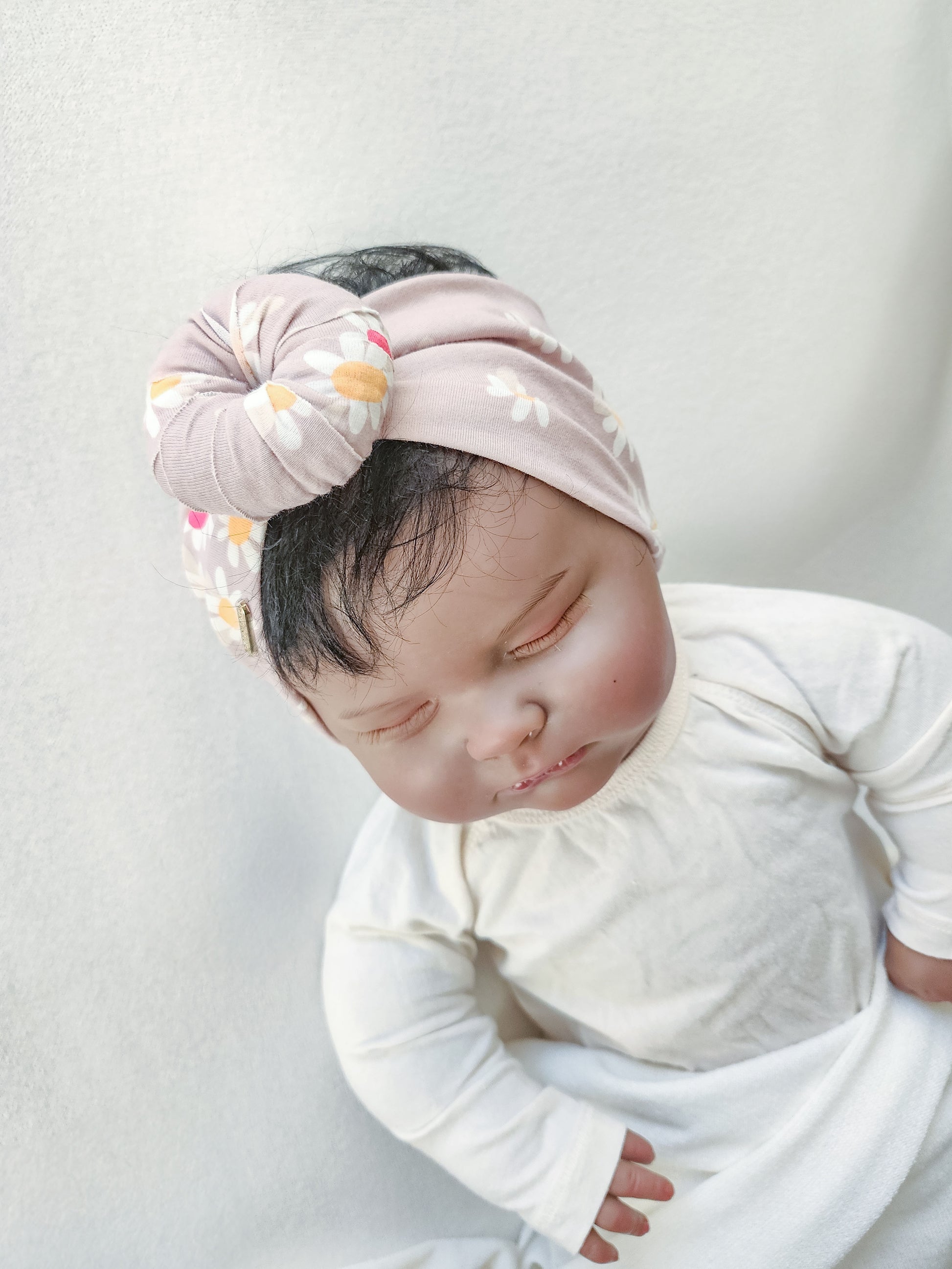 Headband donut in daisy floral print close-up view