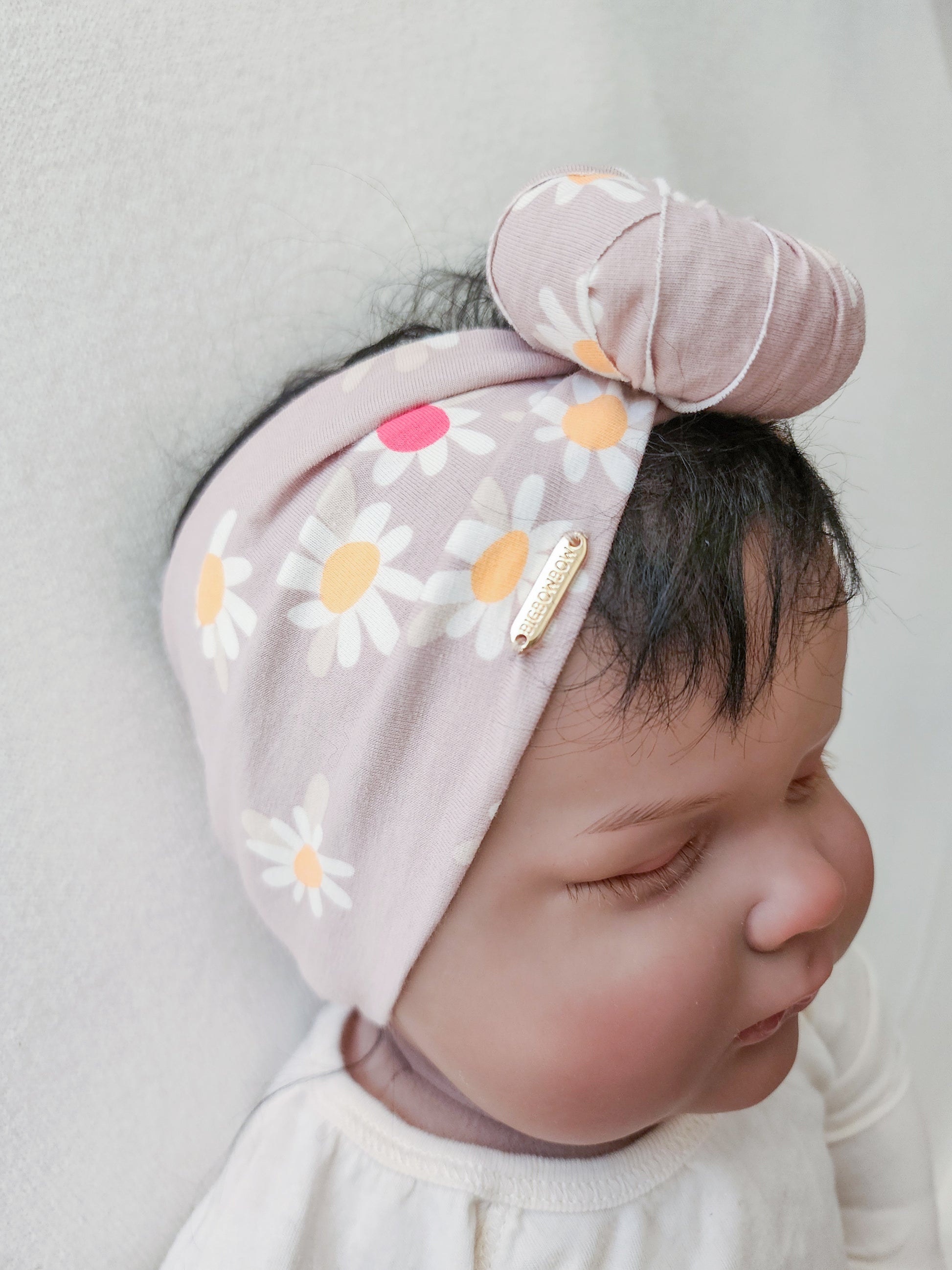 Headband donut in daisy floral print close up side view