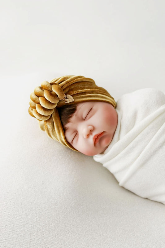 Baby girl velvet turban knot in gold color close-up view