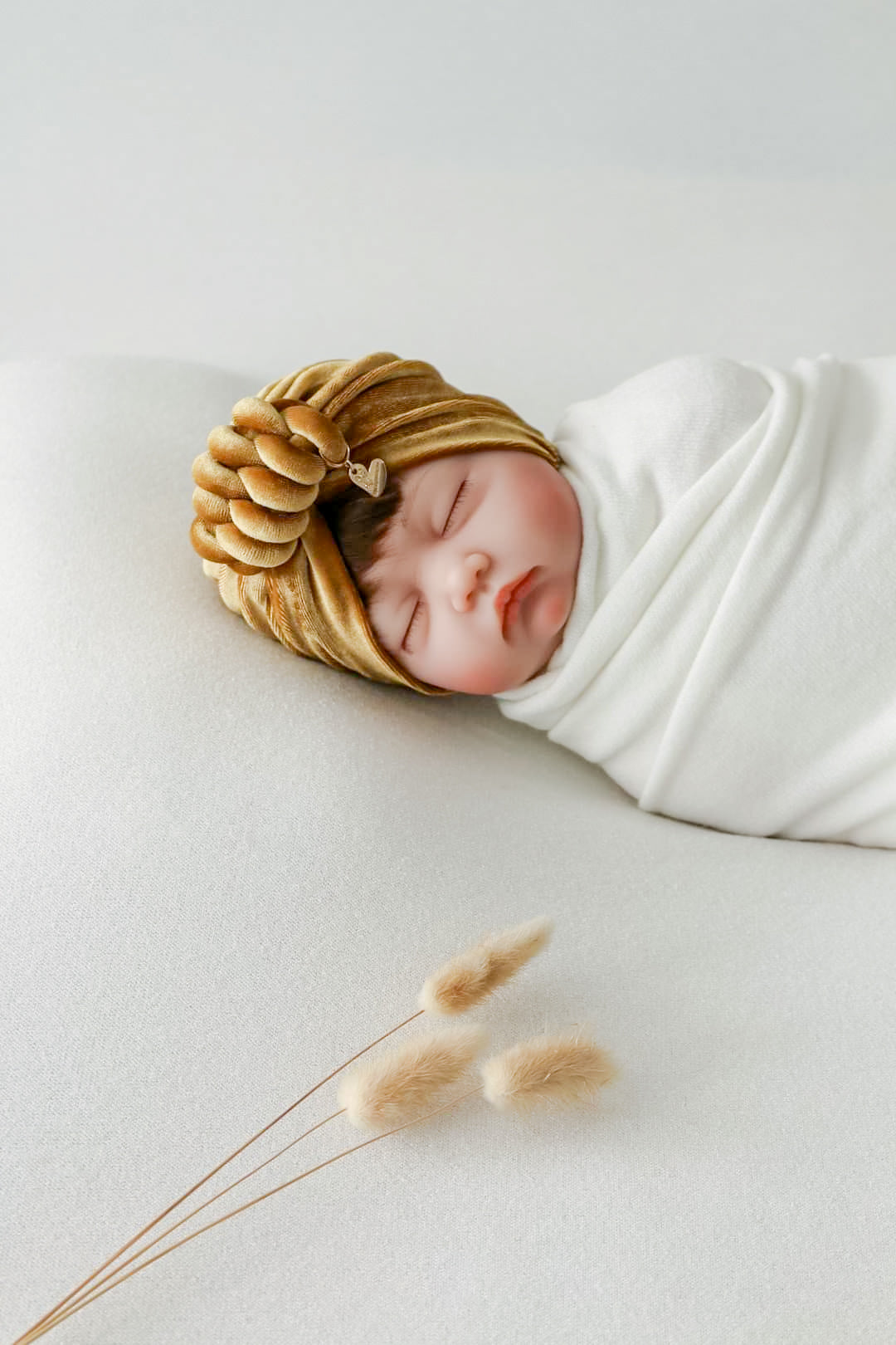 Baby girl velvet turban knot in gold color close-up view