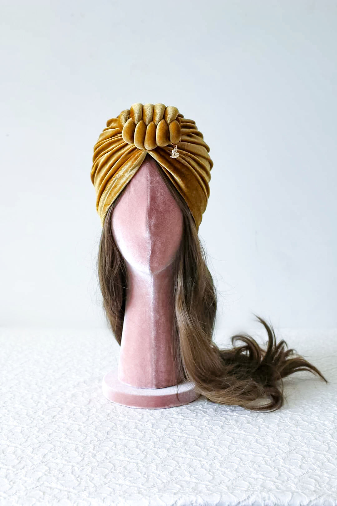 Velvet turban knot in gold color front view