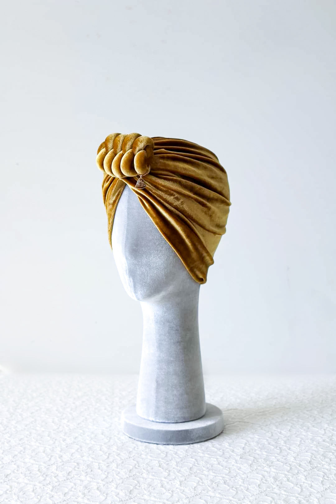 Velvet turban knot in gold color side view