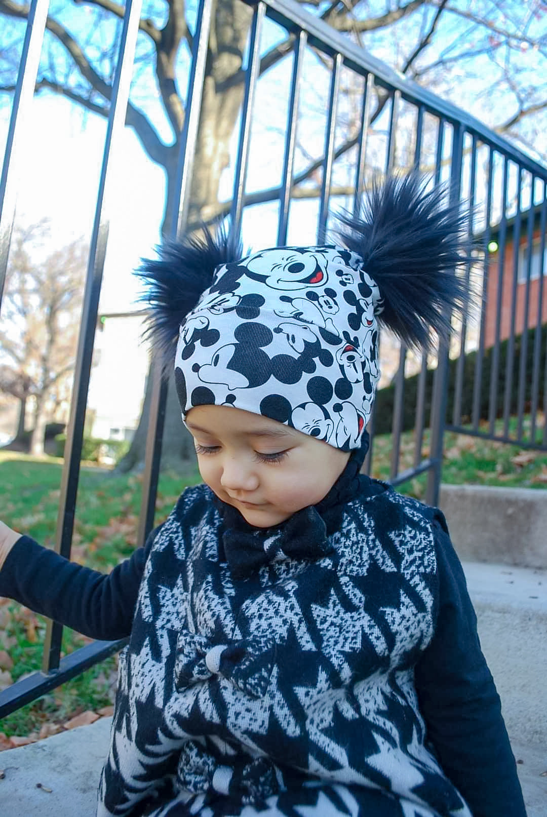 Double pompoms beanie in mickey mouse print side view 