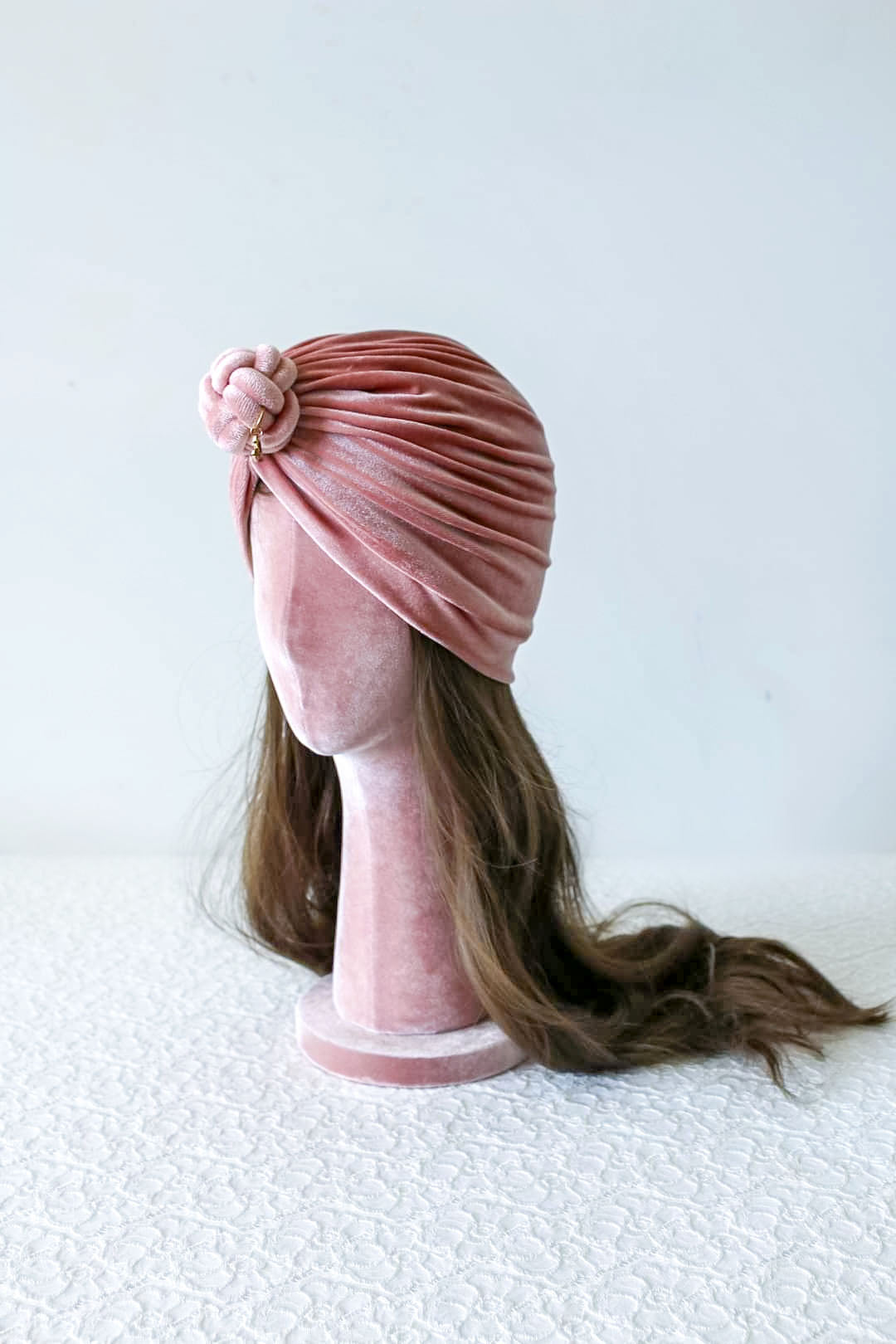 velvet turban knot in details, pink color, turban for women, side view.