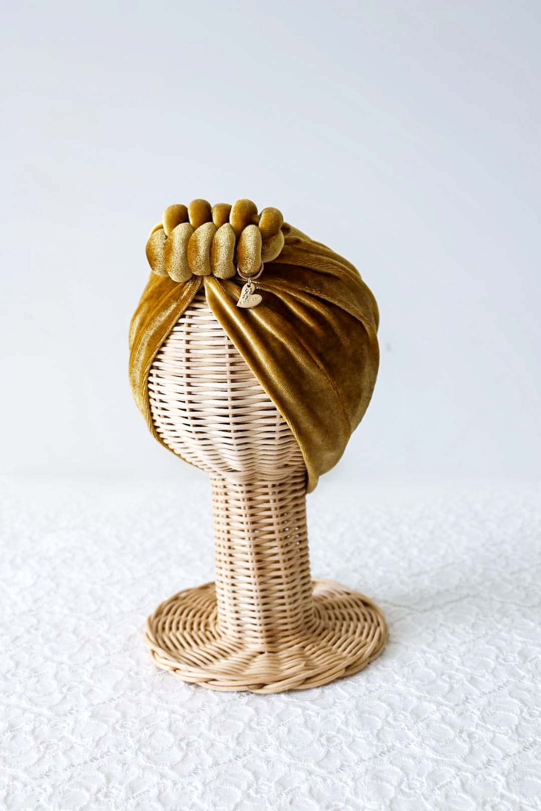 Velvet turban knot in gold color side view